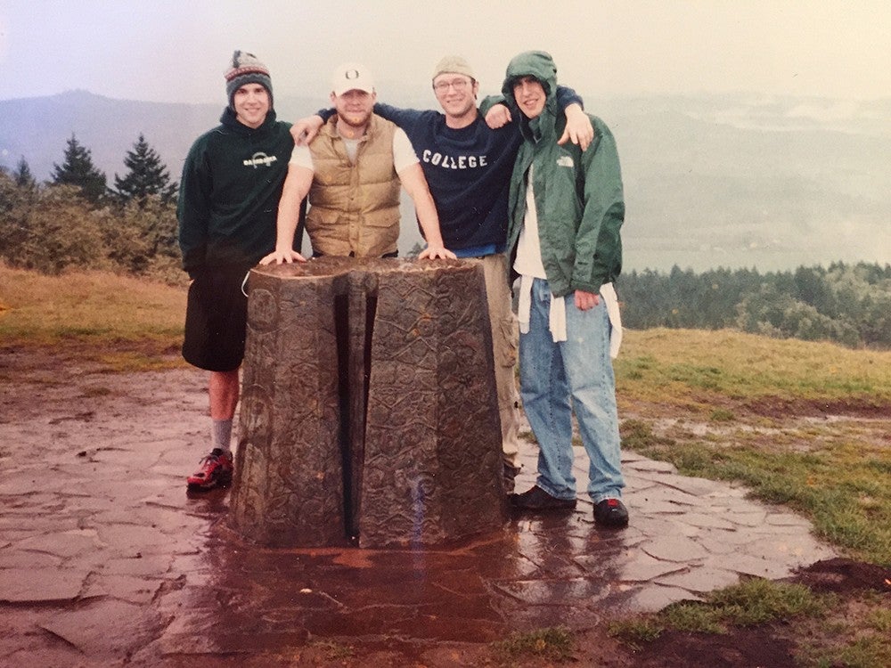 four UO students posing atop mt. pisgah in grainy film photograph